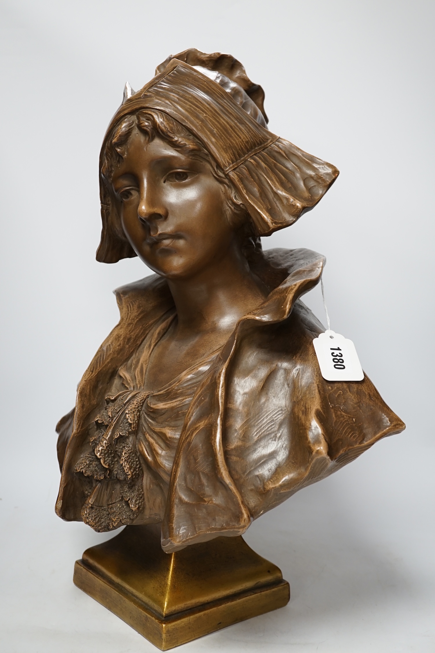 A bronzed terracotta bust of an early 20th century Dutch girl, 55cm high